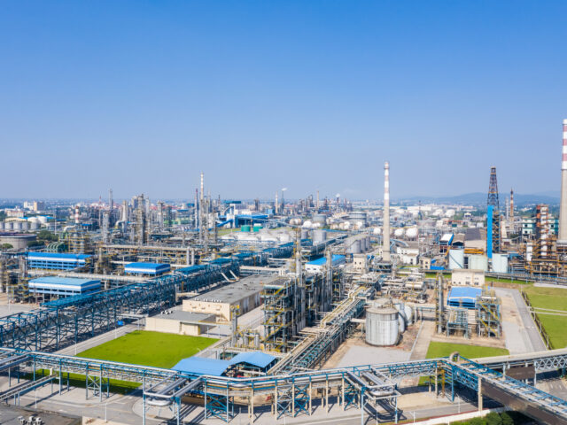 modern petrochemical oil refinery against a blue sky
